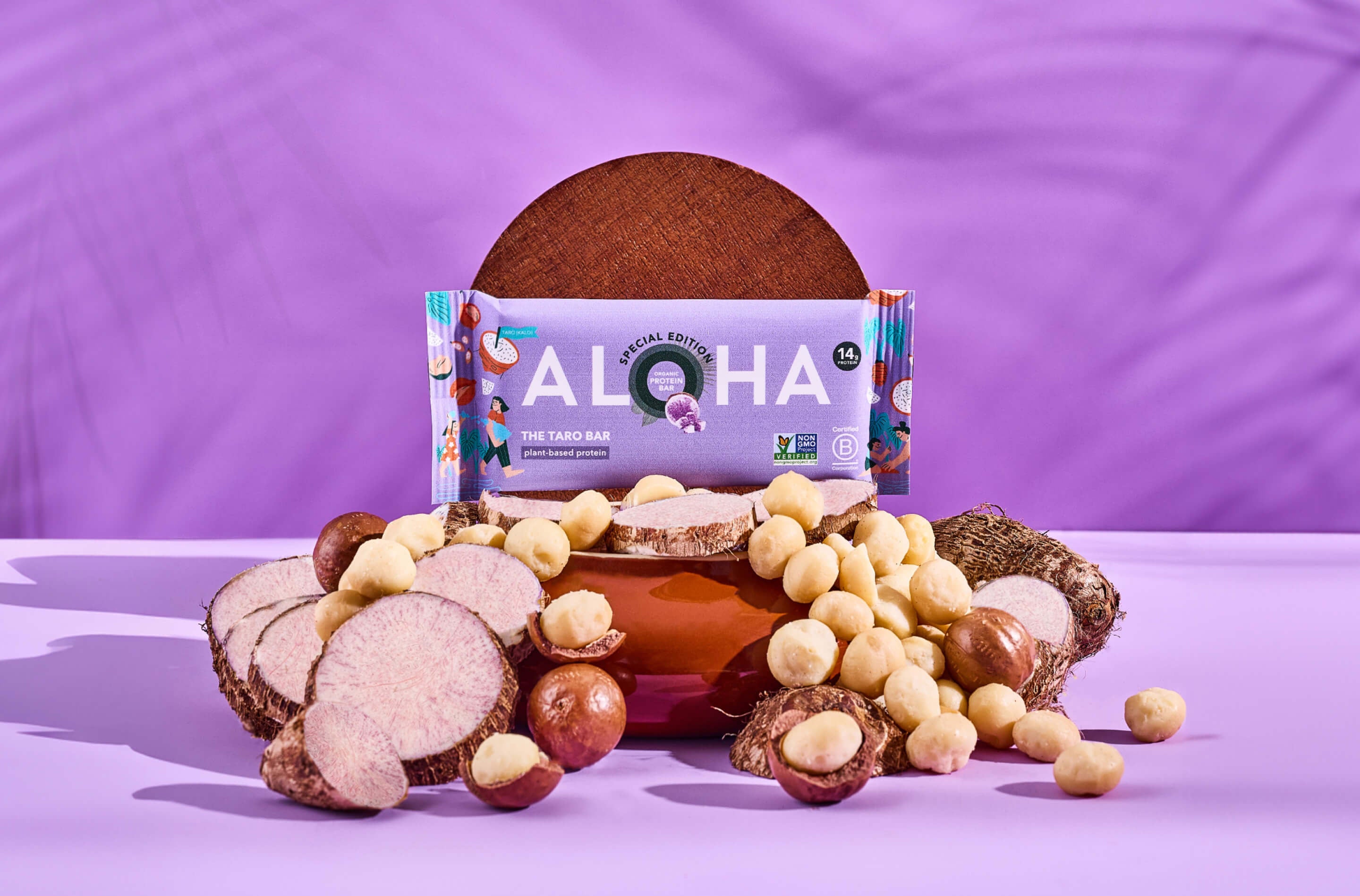 Aloha protein bar with taro and macadamia nuts on a purple background.
