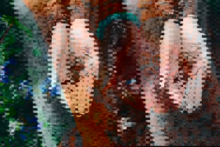 a woman is holding macadamia nuts in her hands